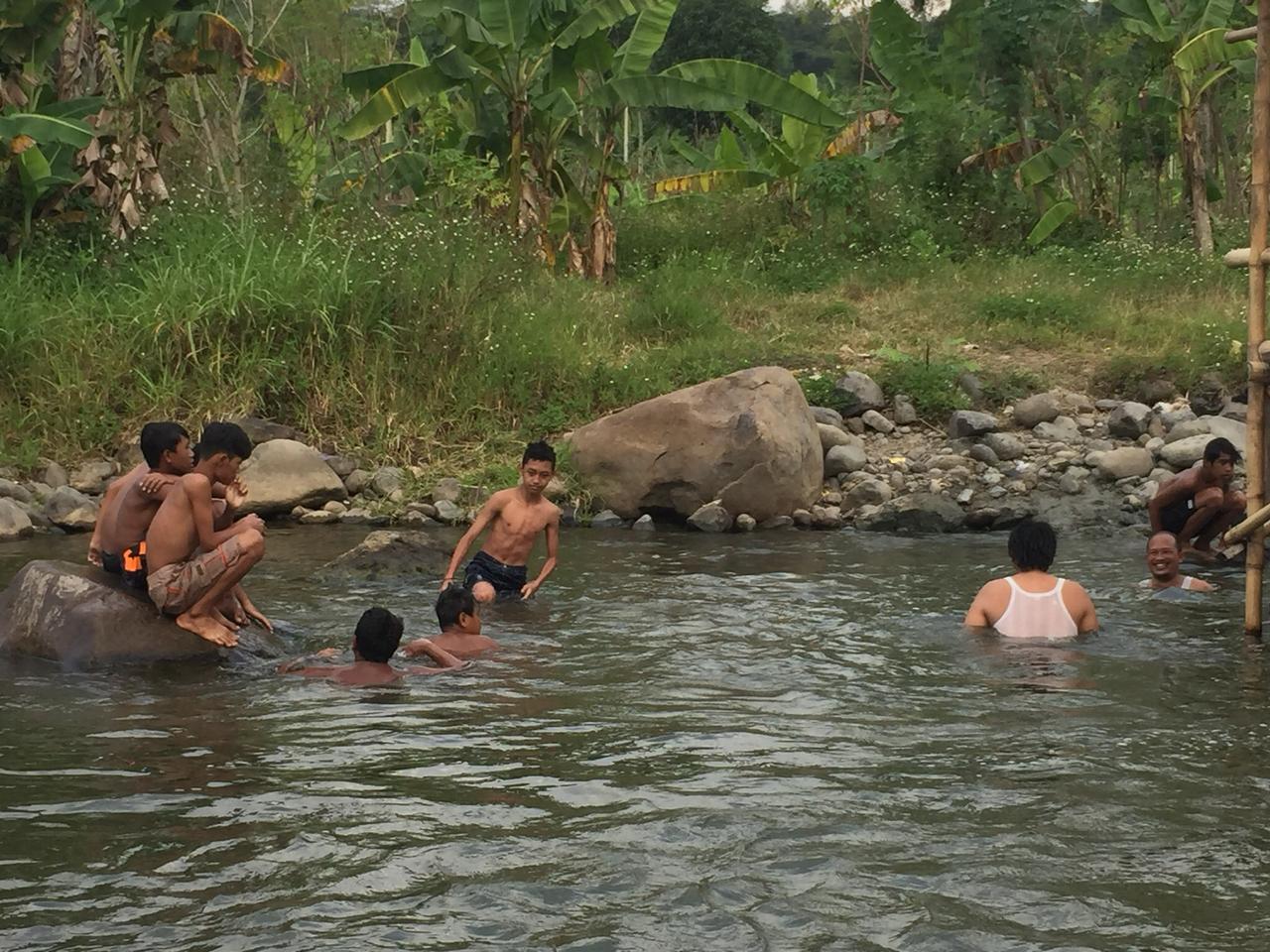 Para pengunjung yang sedang berenang di tepi sungai. [BP2M/Hasnah]