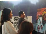 Pengunjung menikmati lukisan dalam pameran seni Beyond Religion, Sabtu (8/6) [Magang BP2M/Anastasia]