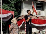 Presiden Mahasiswa BEM KM Unnes, Baharudin Wahyu Aji Dwi Sajiwo, dihampiri oleh ketua panitia dari unsur dosen saat memberikan sambutan dan orasinya pada pembukaan PKKMB Unnes 2024 di Lapangan Prof. Dumadi, Jum'at (16/8). [Dok. Intan Maghfiroh, Mahasiswi Unnes]