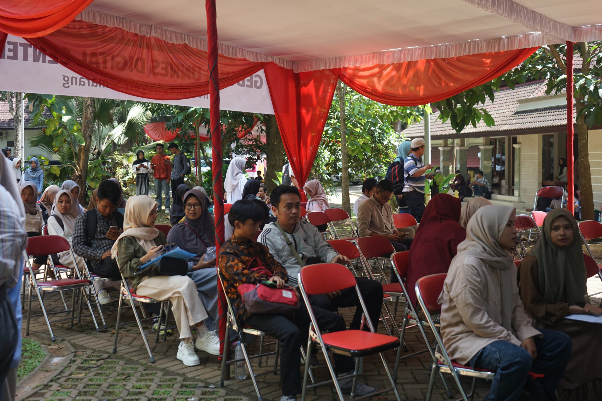 Terduduk peserta UTBK dan pendampingnya di bawah tenda sambil memunggu sesi pertama berakhir. (Rabu, 23 April 2025) [Gusti/BP2M]
