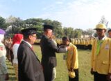 Rektor Unnes memberikan ID card sebagai simbol penyambutan mahasiswa baru di lapangan Prof. Dumadi, Minggu (17/8) [Sultan/BP2M]